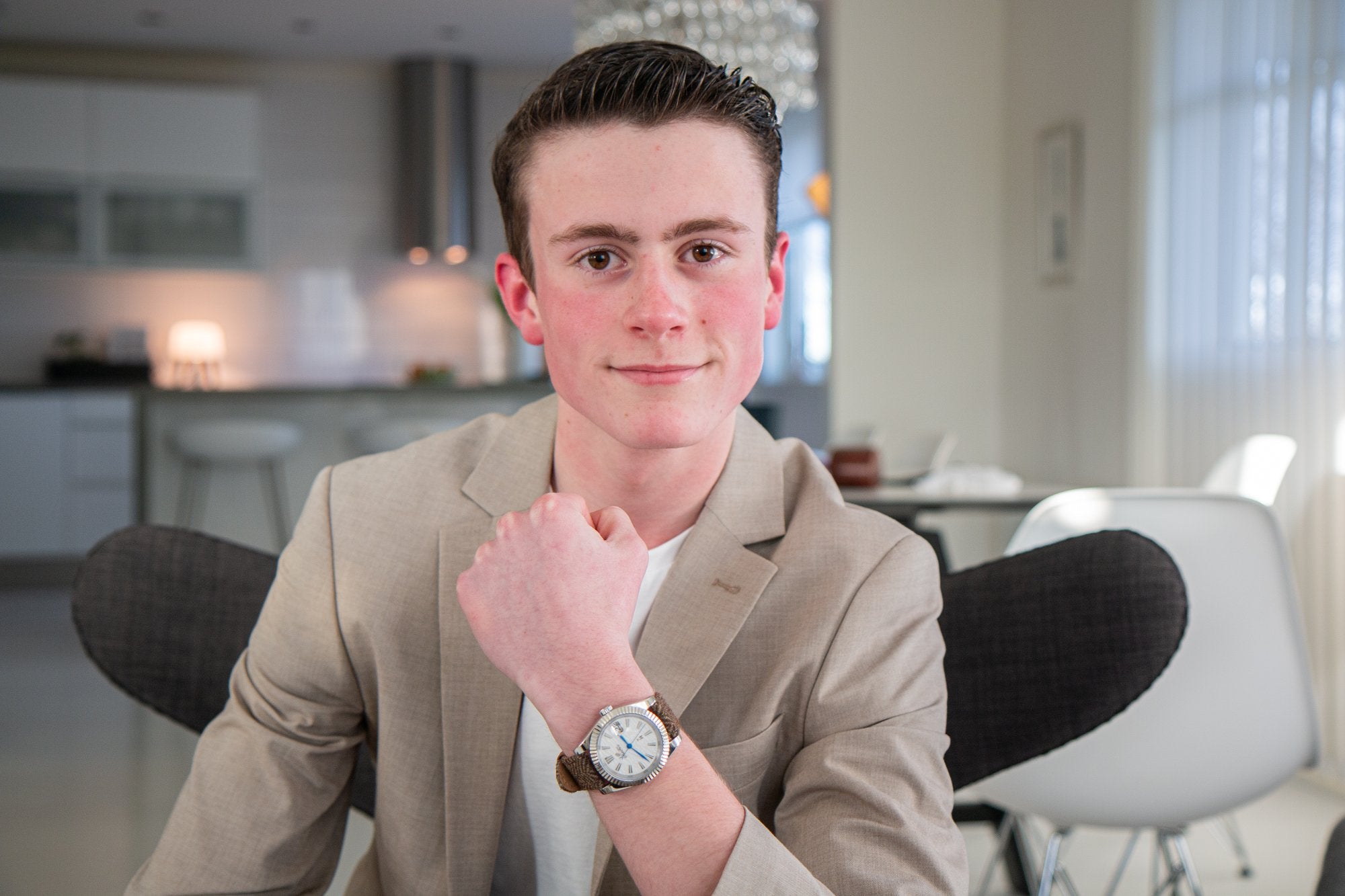 Portrait of the founder in a beige jacket wearing a watch